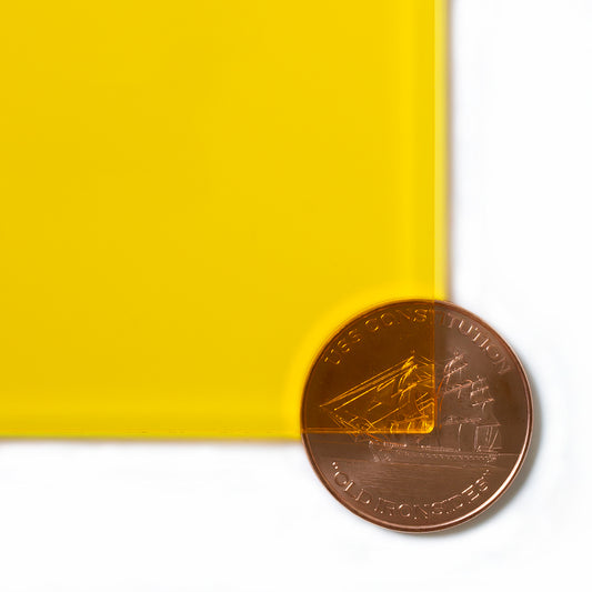 2208 Yellow transparent cast acrylic sheet sample with penny for scale