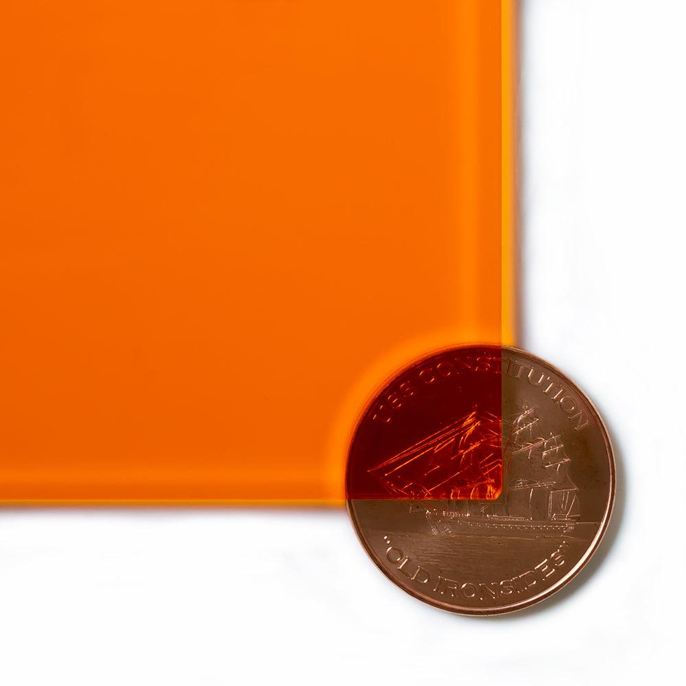 2422 Amber transparent cast acrylic sheet sample with penny for scale