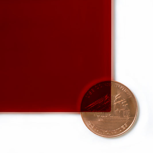 2423 Red transparent cast acrylic sheet sample with penny for scale