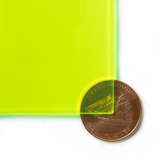 9093 Fluorescent Green edge-glow cast acrylic sheet sample with penny for scale