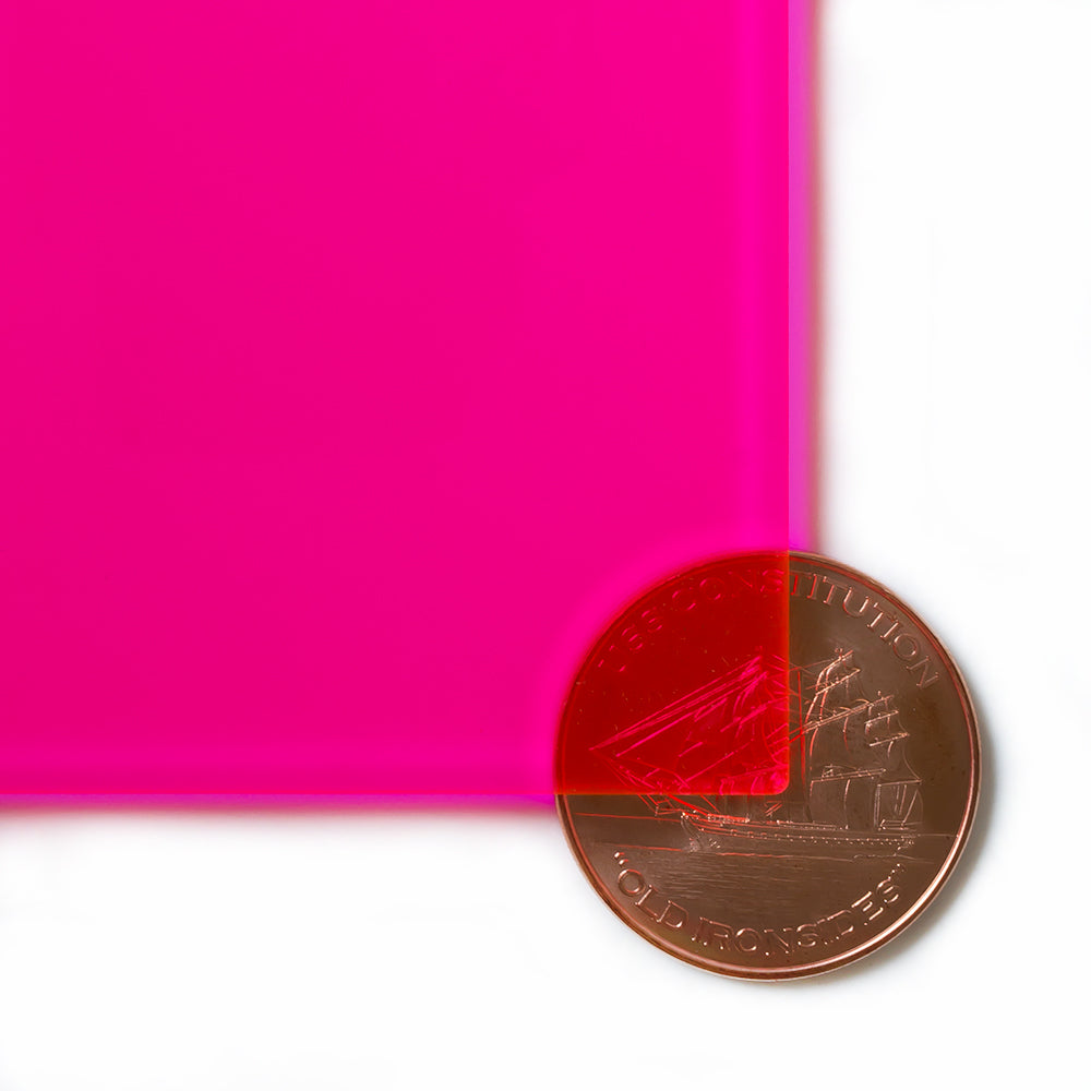 9095 Fluorescent Pink edge-glow cast acrylic sheet sample with penny for scale
