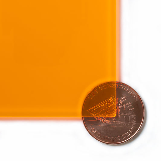 9096 Fluorescent Orange edge-glow cast acrylic sheet sample with penny for scale